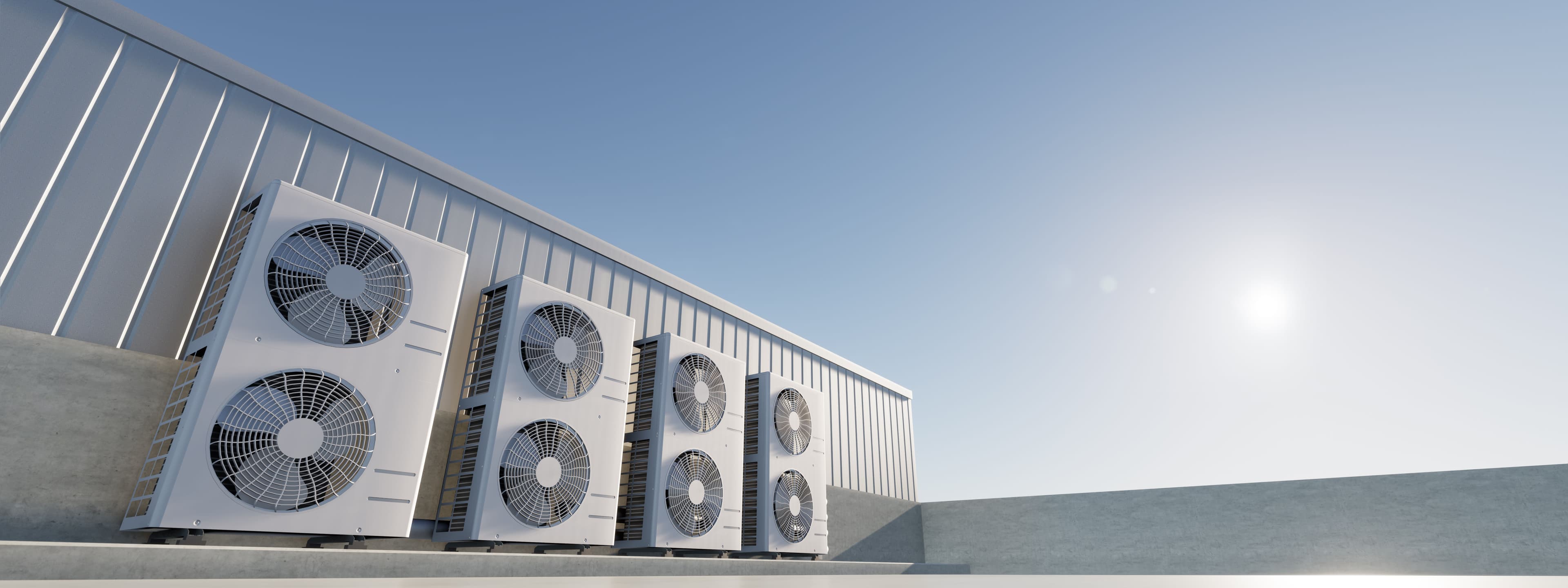 Commercial HVAC units on a rooftop under a clear blue sky, ensuring efficient climate control.