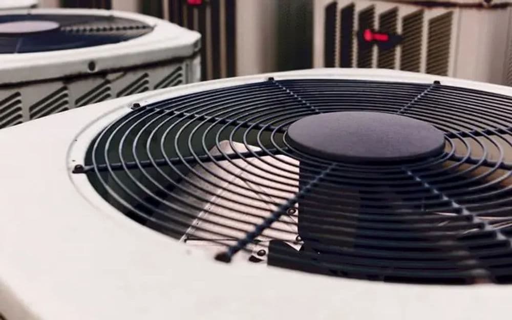 Close-up of air conditioning unit fan, showcasing cooling system components.